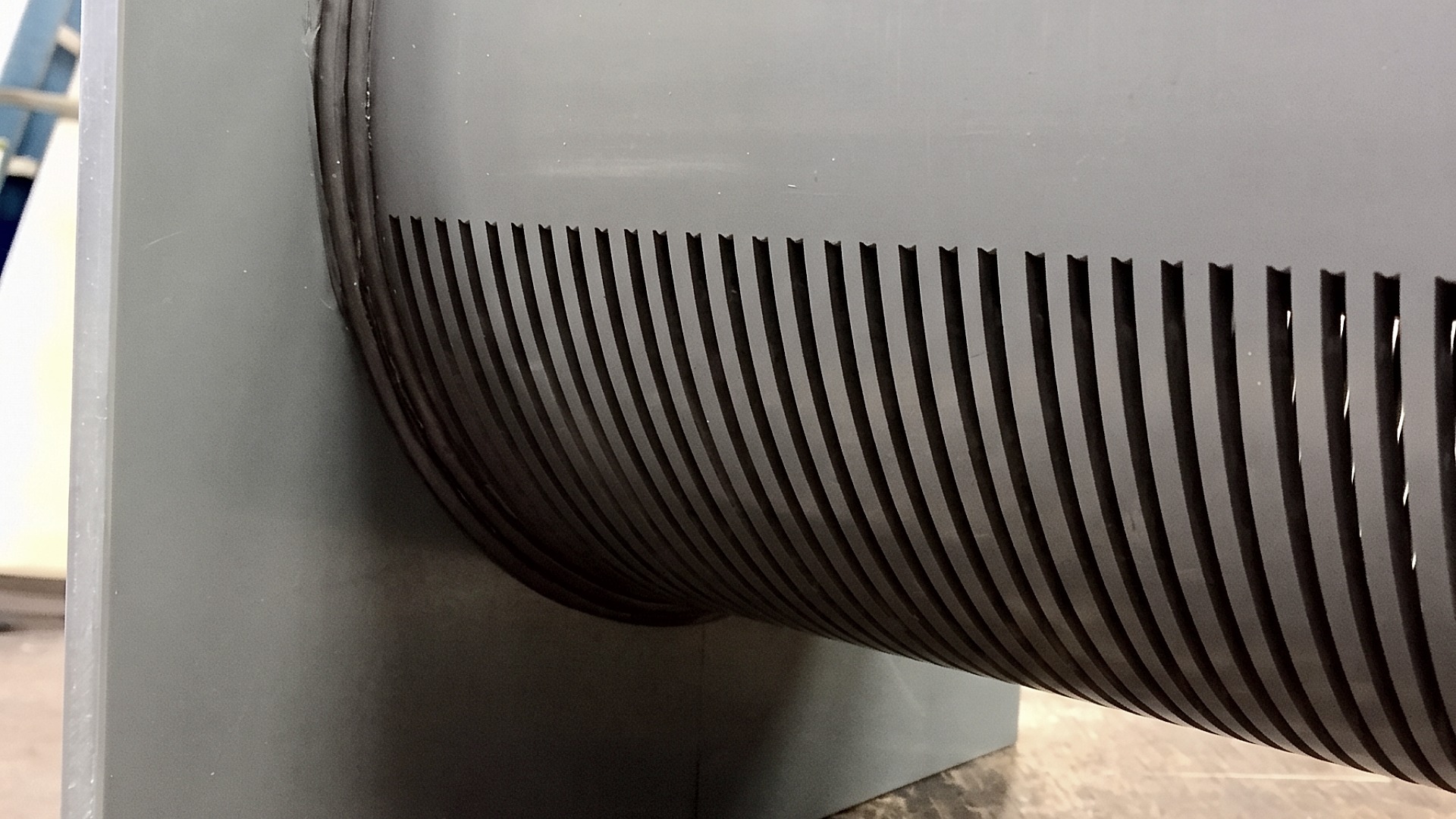A close up image showing grooves cut into a custom pipe setup for use in air sparge mixing and blending tanks