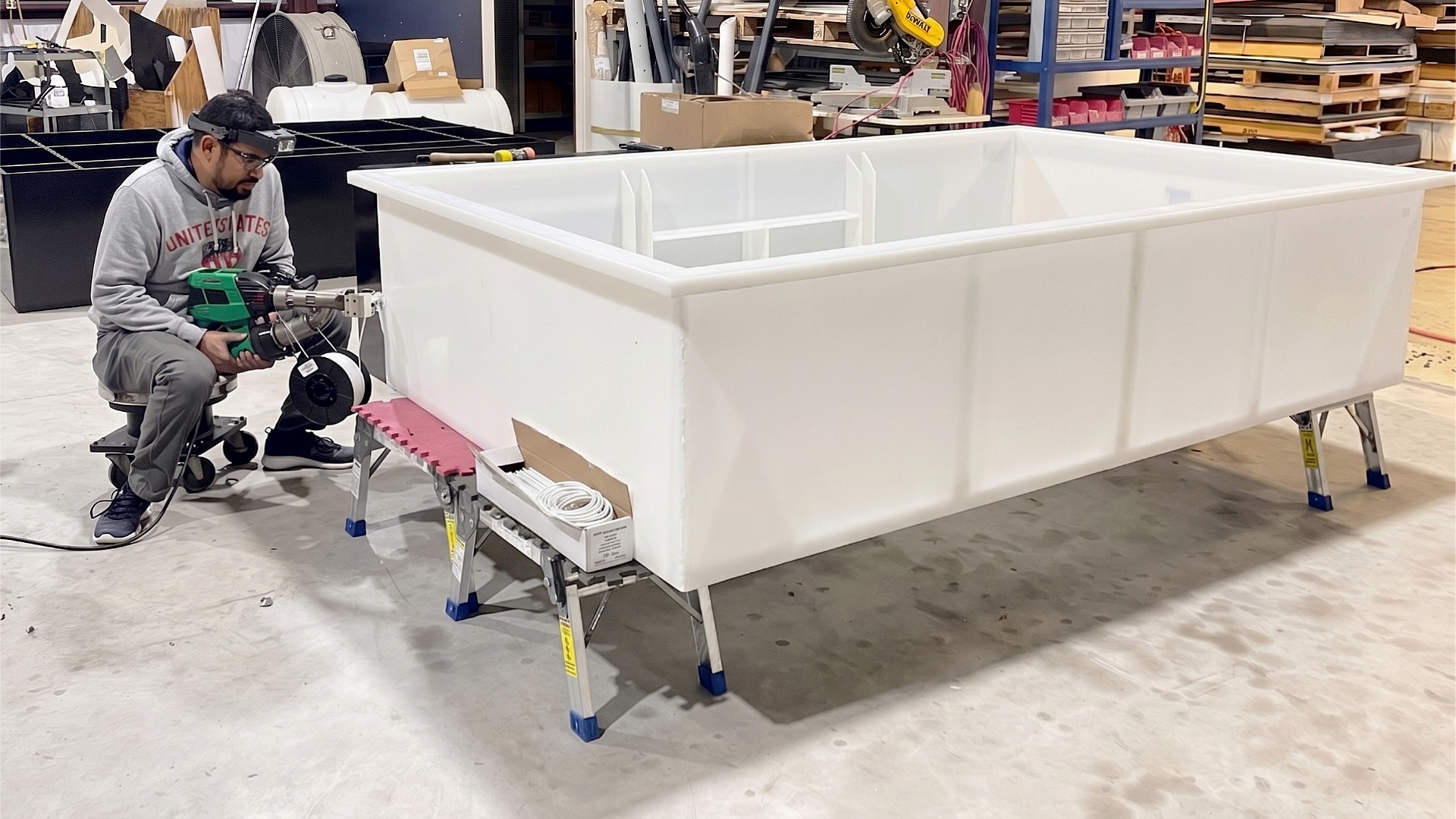 An image showing a tank fabrication specialist using extrusion welding to construct a custom PP dip tank.
