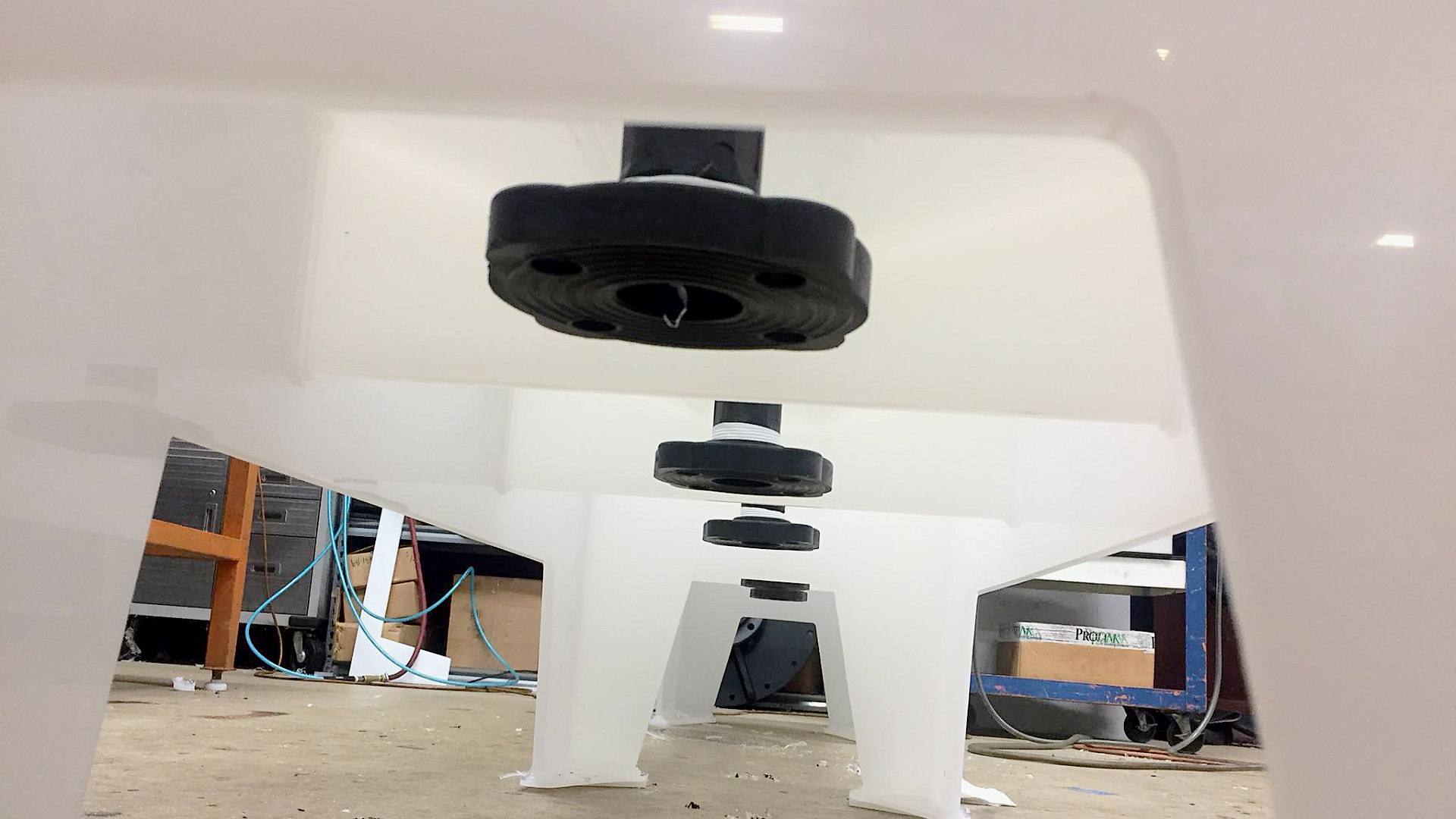 Close up of custom placed bottom drain flange fitting on custom polypropylene tank