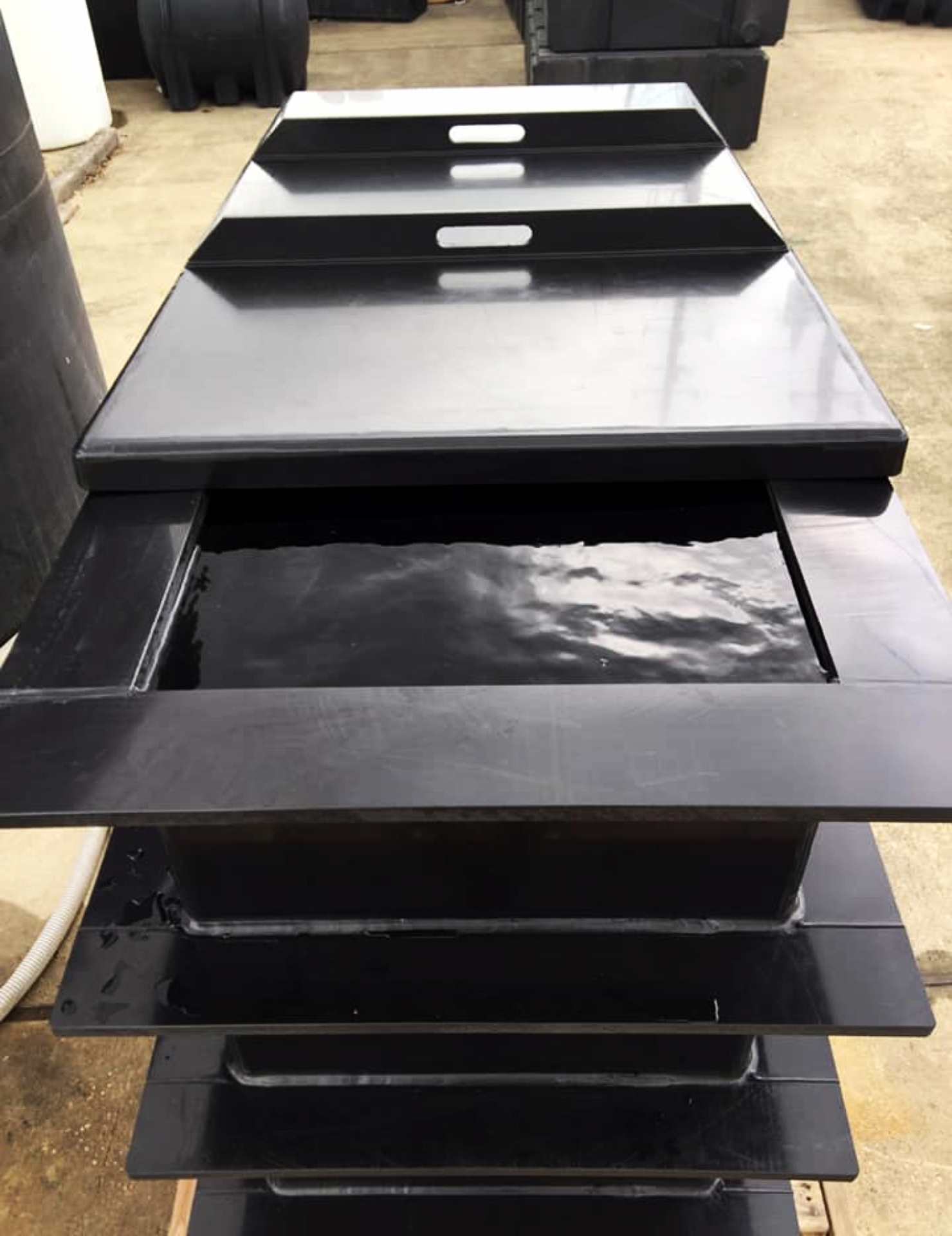 A custom polypropylene multi-stage dip tank with a removable multi-piece lid and integrated handles
