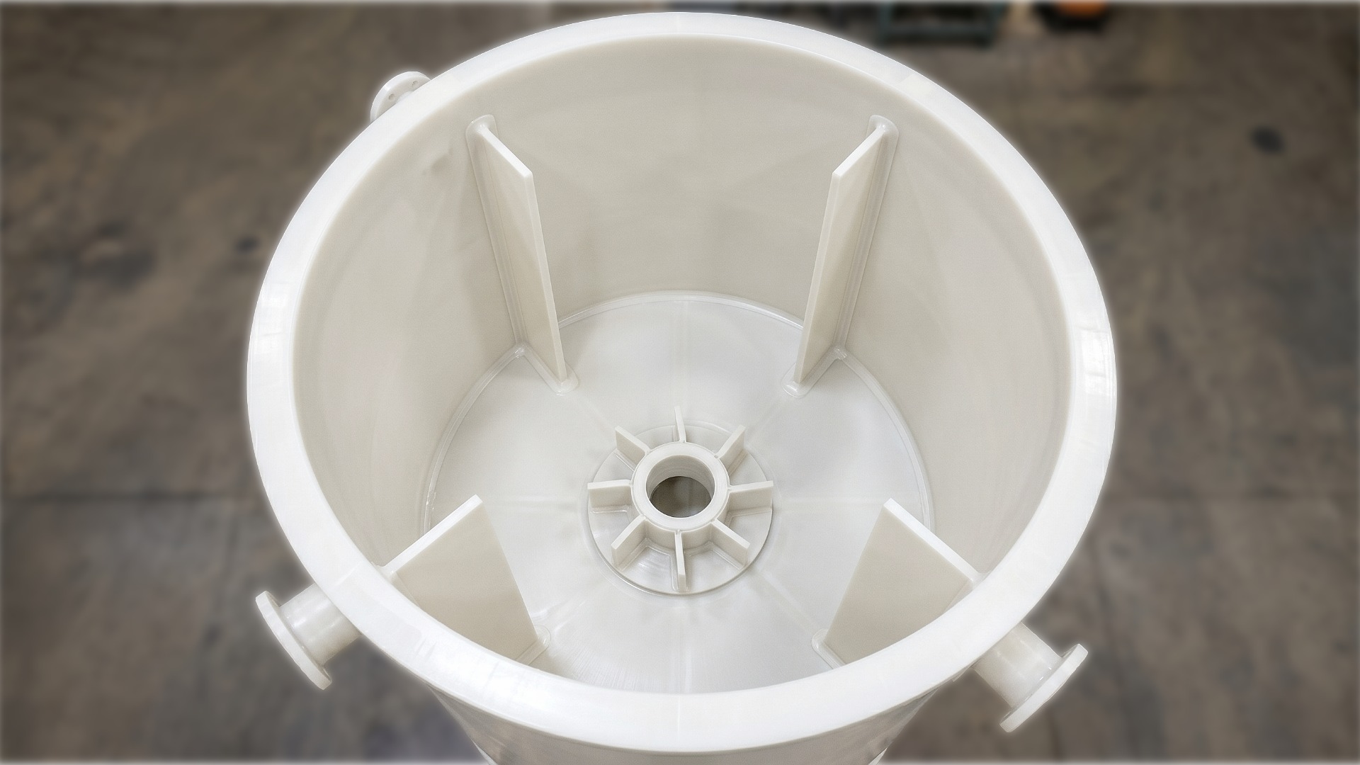 Interior top down view of a custom white open top polypropylene wastewater tank with baffles