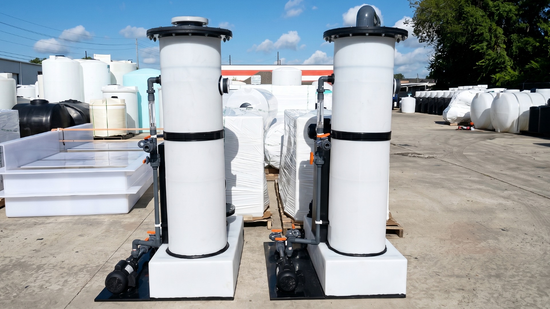 Two custom process liquid and vapor handling tanks with piping, valves, and pumps