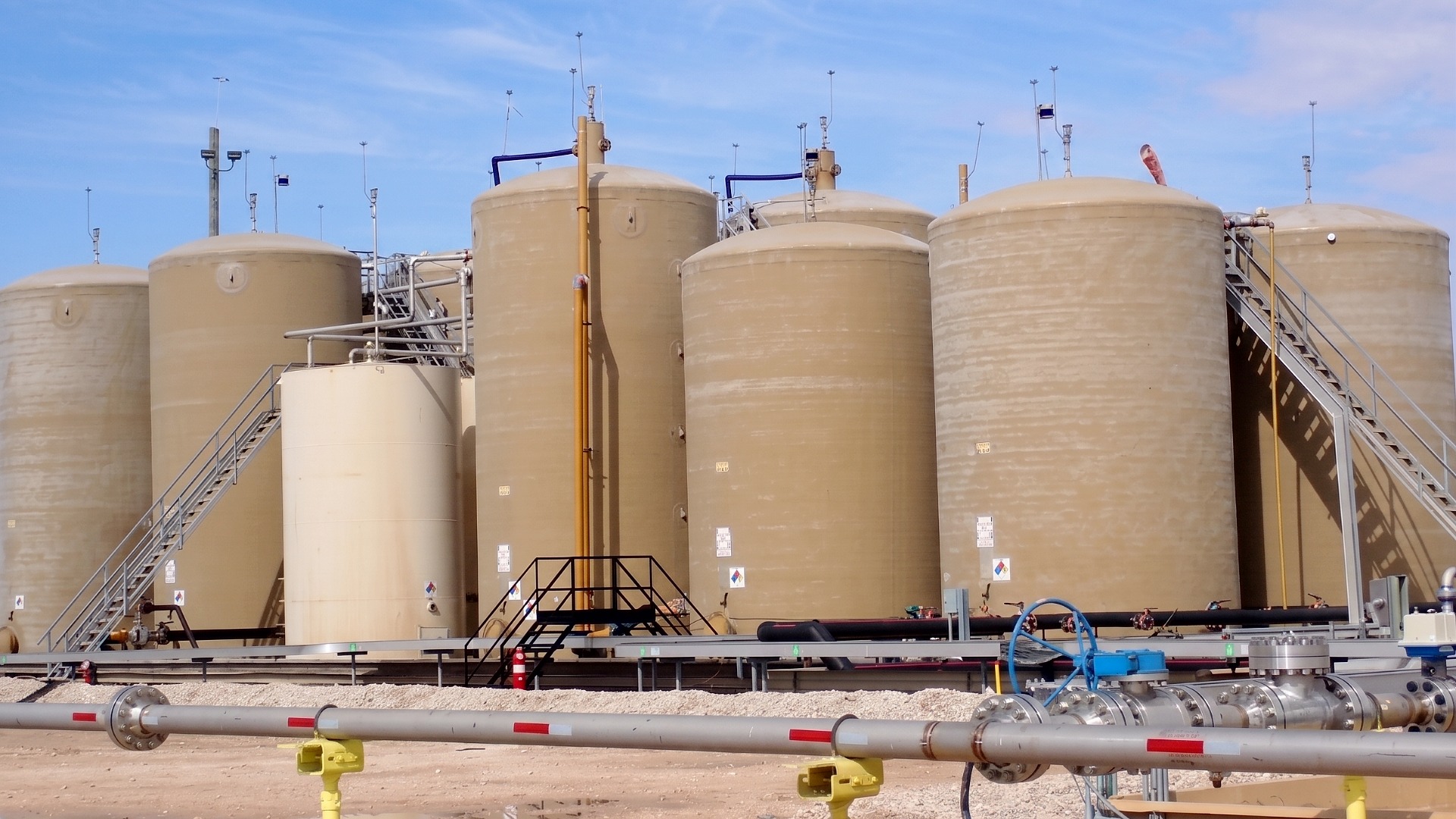 Fiberglass tank array showing multiple FRP tanks of various sizes and capacity to handle different fluids in different systems for the same facility