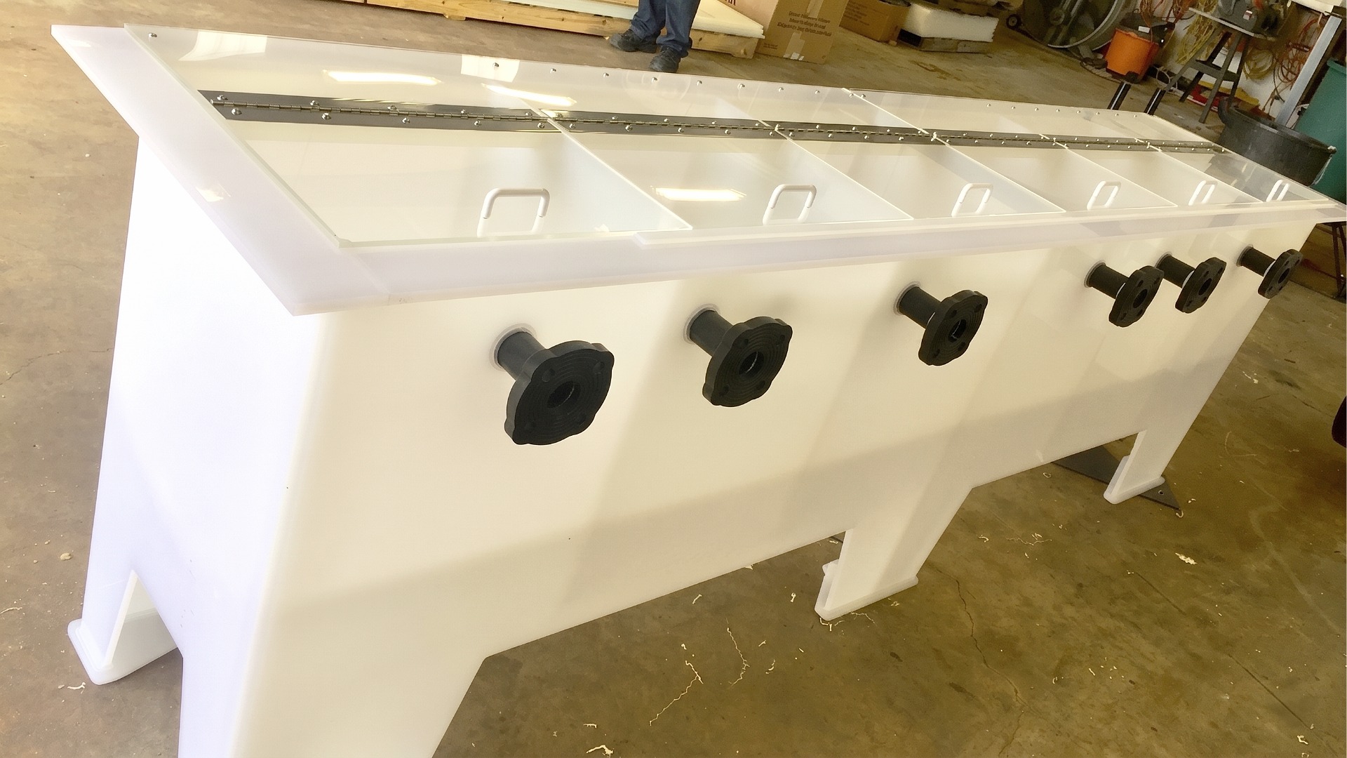 Multi-compartment white plastic tank with individual clear hinged lids and black flange fittings for separate liquid processing