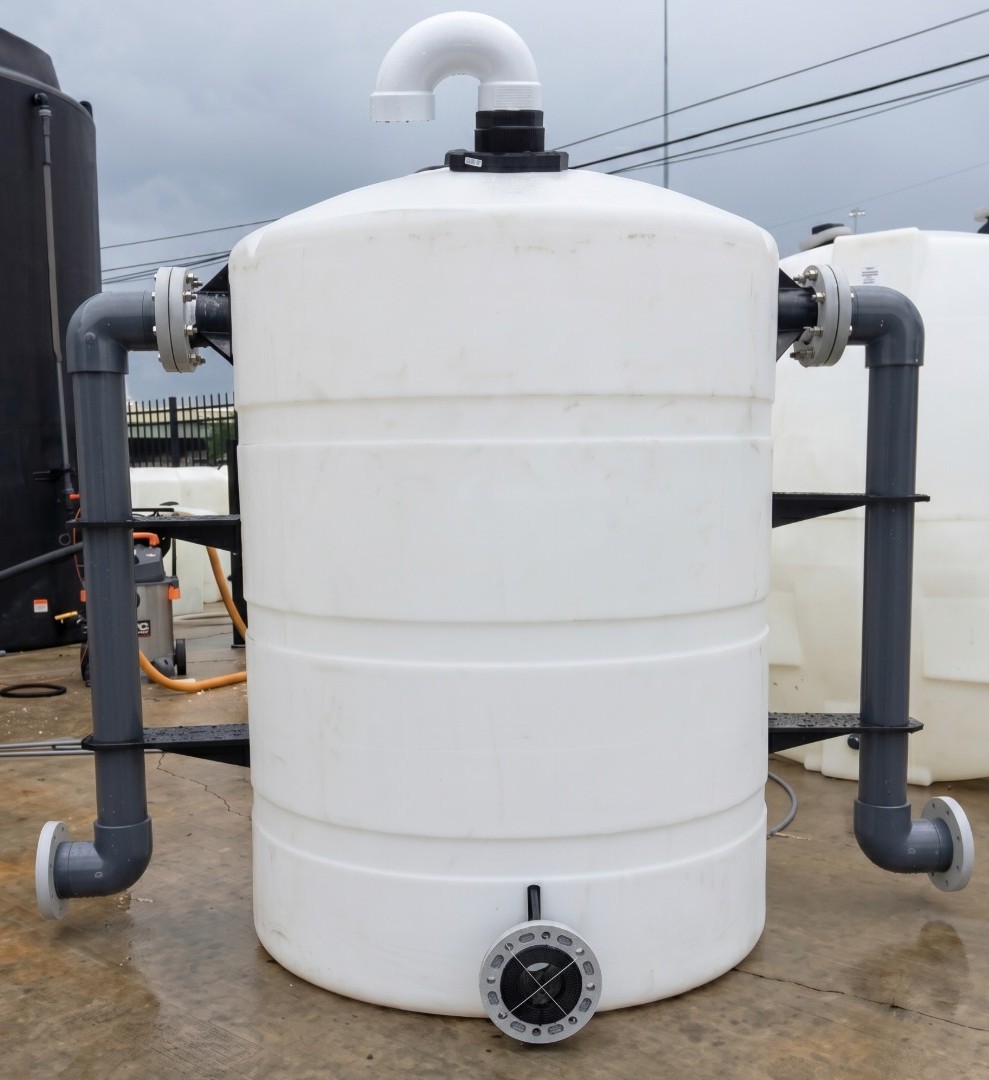 Custom fitted HDPE chemical tank with inlet/outlet piping, flanges, and vent