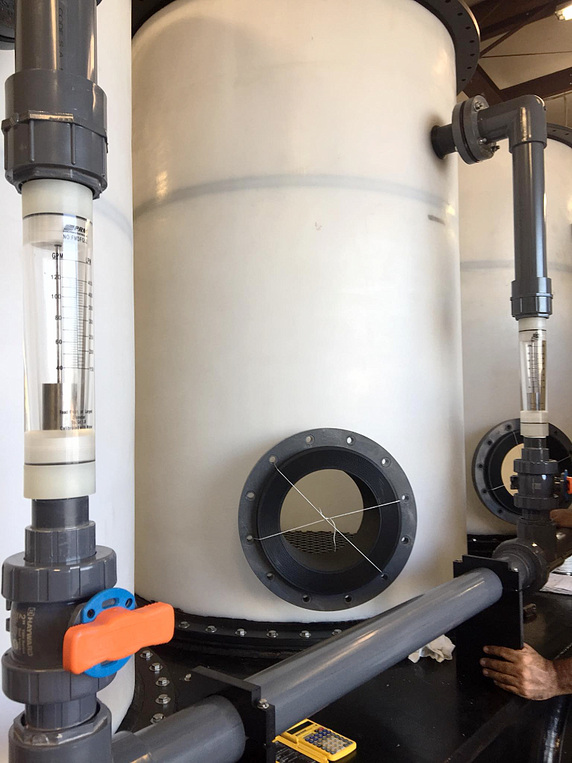 Customized poly tank with a vertical flow meter and PVC manifold with Hayward ball valve
