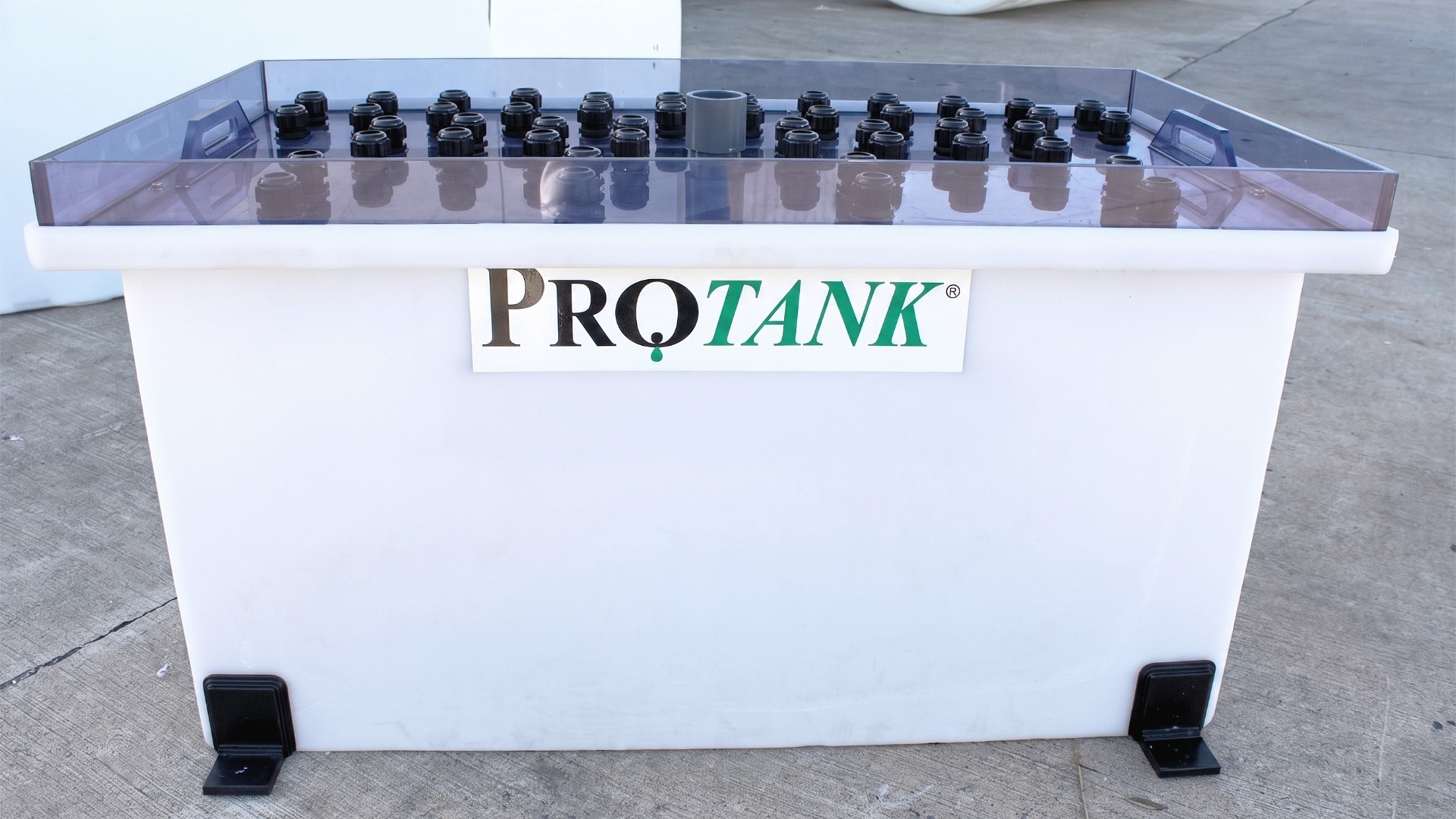 Side view of Protank custom polypropylene tank with transparent lid and dozens of bulkhead fittings