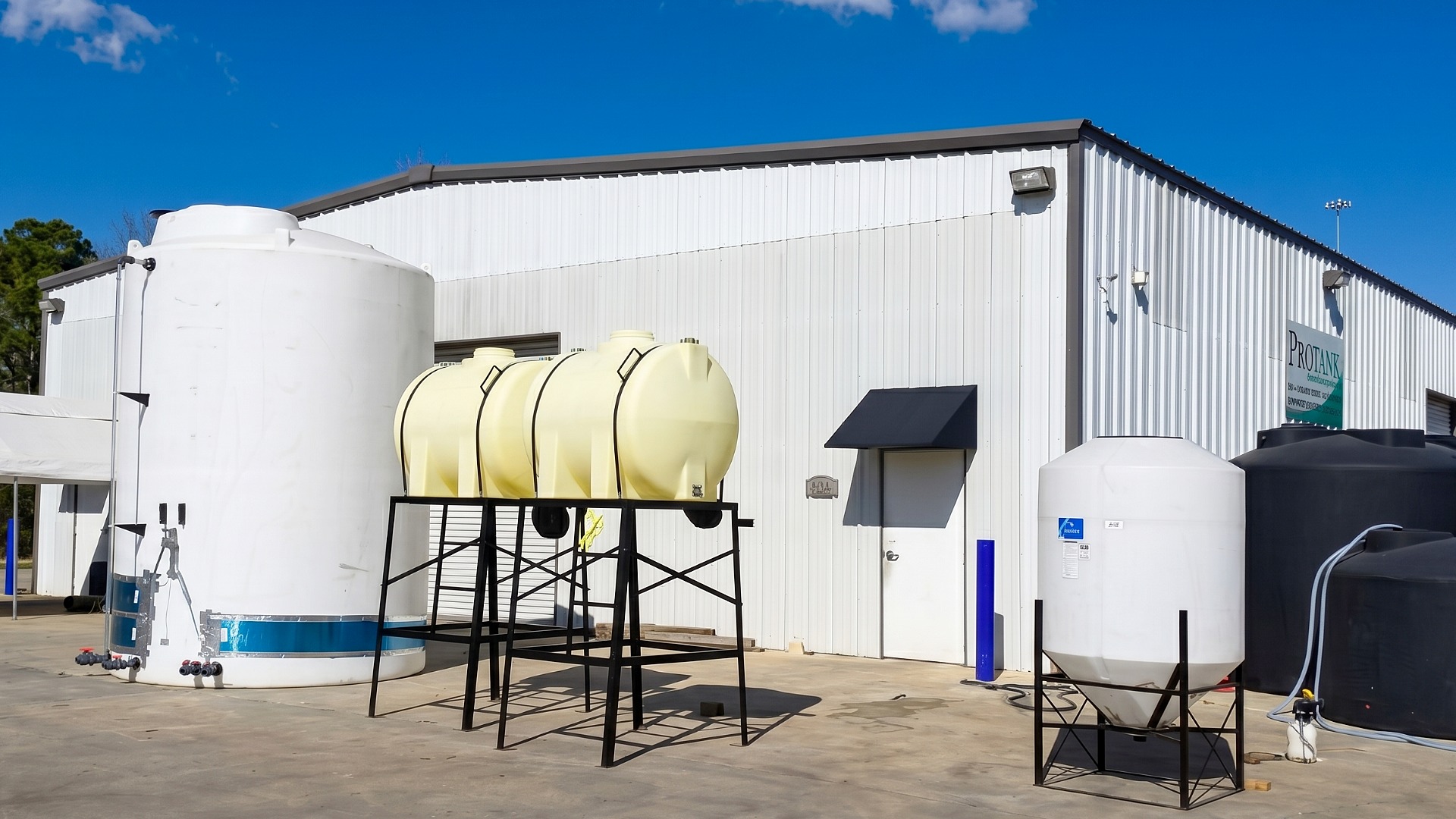 Several customized and outfitted industrial storage tanks staged outside the Protank facility